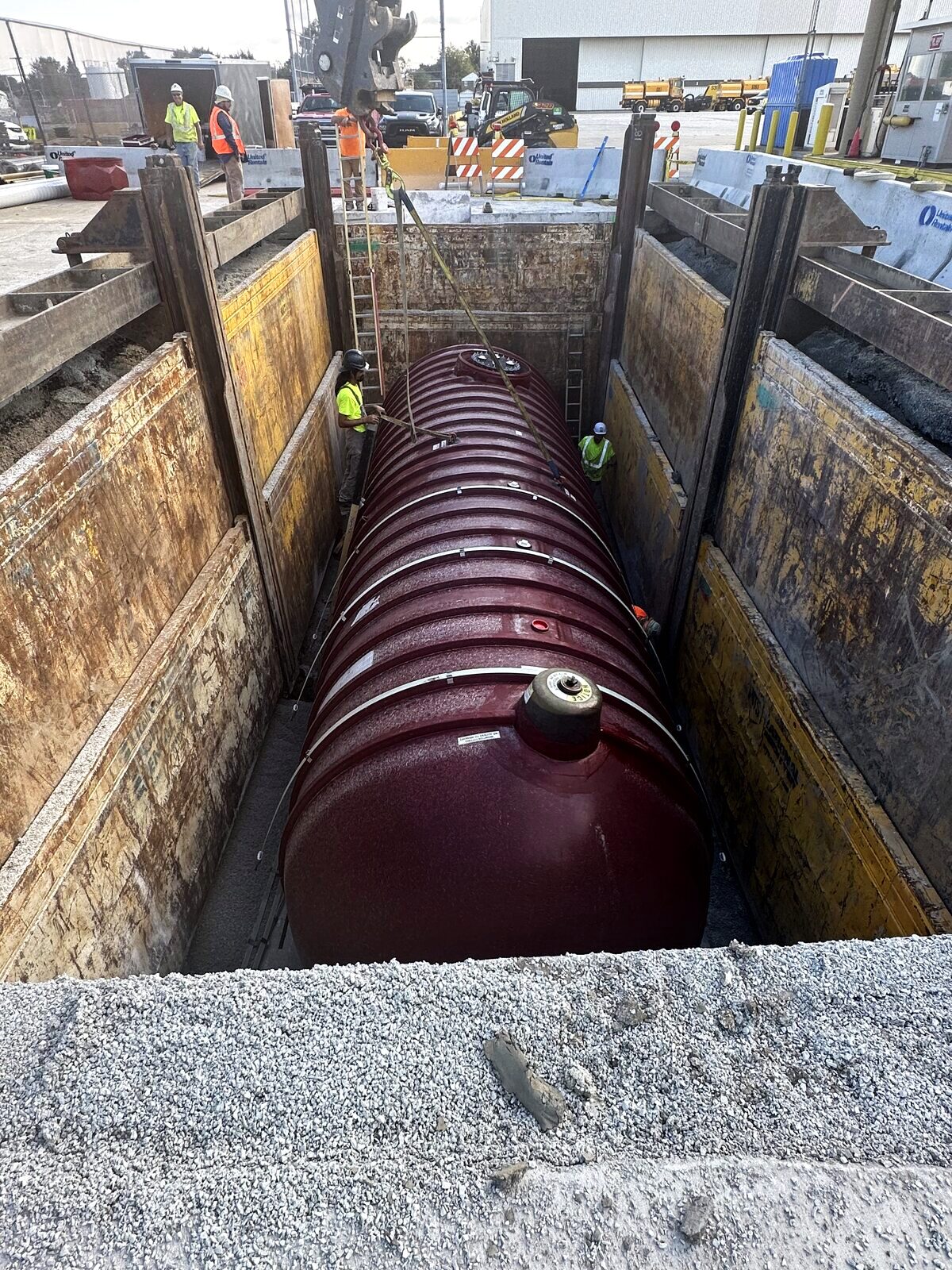 Underground storage tank set in a shored excavation during change-out
