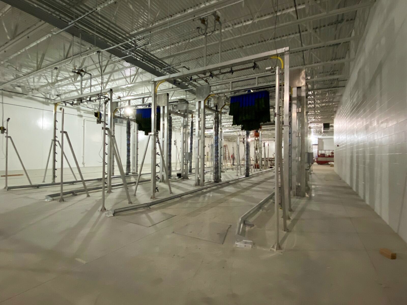 Wash bay gantry structures erected inside the building